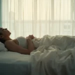 Person doing breathing exercises in bed for better sleep