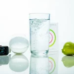 Smart hydration concept with glass of water, smartwatch, and fruit