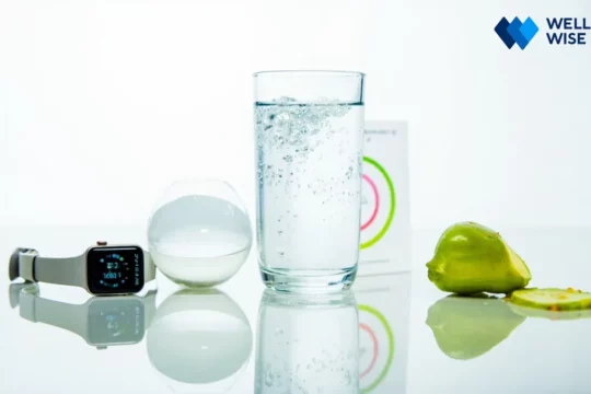 Smart hydration concept with glass of water, smartwatch, and fruit
