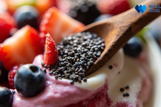 Chia seeds in a bowl with a spoon, next to a yogurt and berry parfait