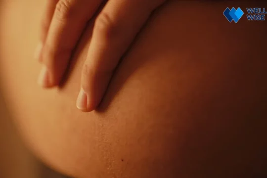 Person indicating upper right abdominal discomfort, a potential subtle sign of fatty liver disease.