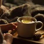 Child drinking herbal tea and honey for cough relief at night